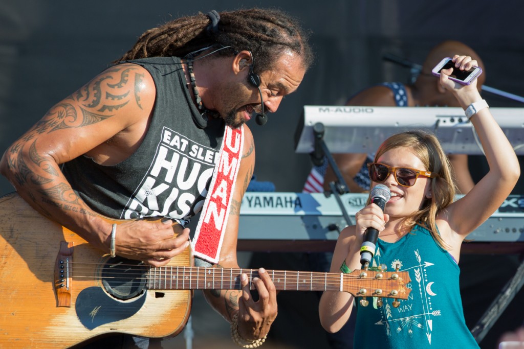 Michael Franti and guest in a happy off